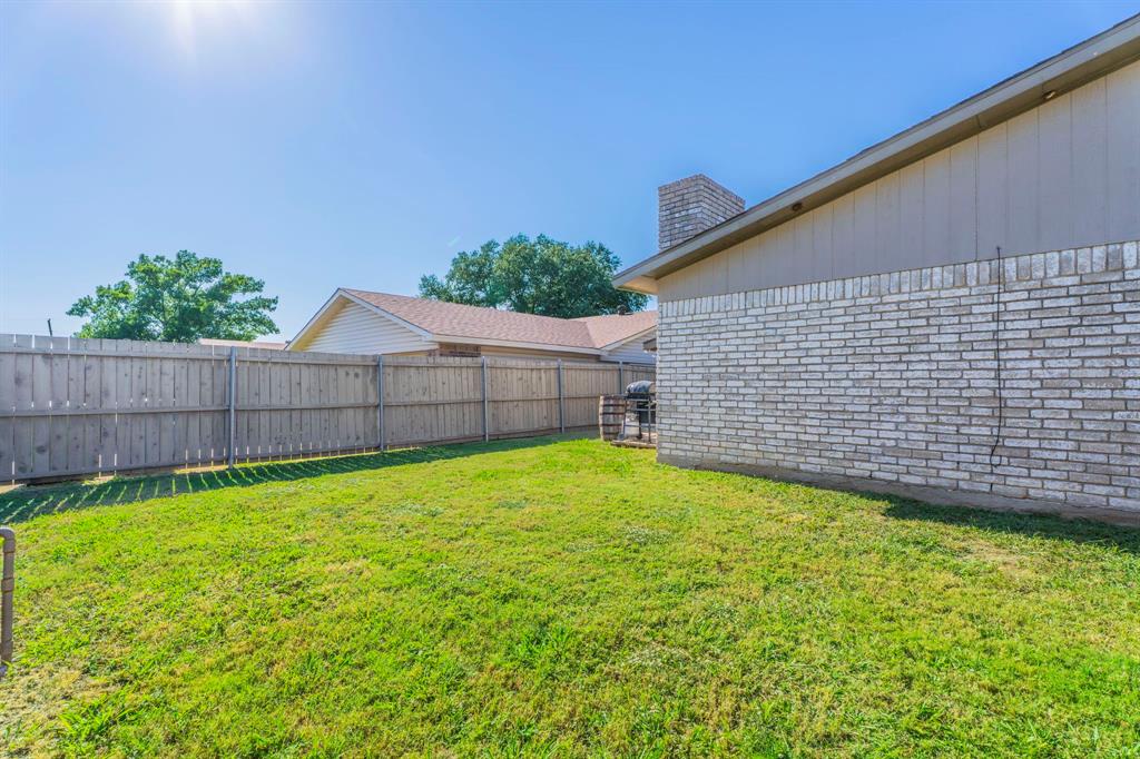 5109 Reed Drive The Colony, TX 75056 - Photo 12 of 14 a view of a backyard with a garden