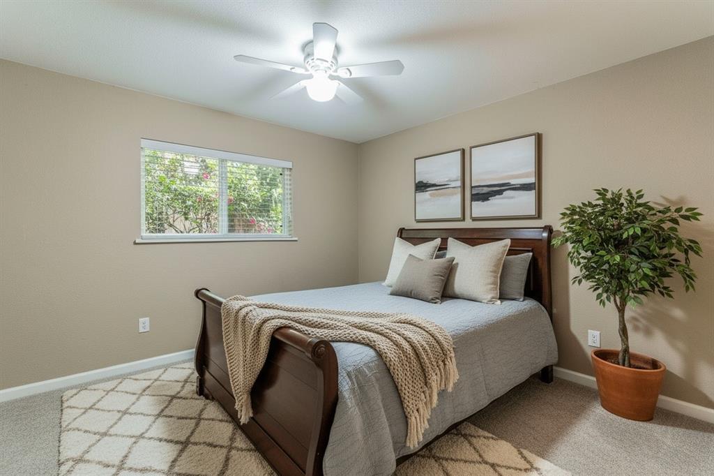 5109 Reed Drive The Colony, TX 75056 - Photo 9 of 14 a bedroom with a bed and a potted plant