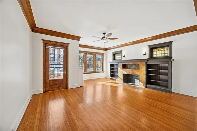 a view of a livingroom with wooden floor and fireplace