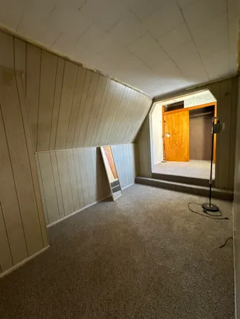 a view of a hallway to an empty room and closet