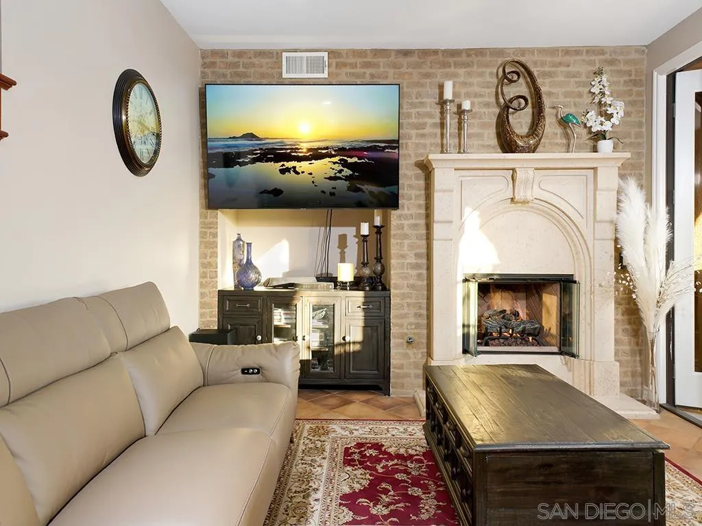 33 Tuscany Ladera Ranch, CA 92694 - Photo 11 of 50 a living room with furniture a flat screen tv and a fireplace