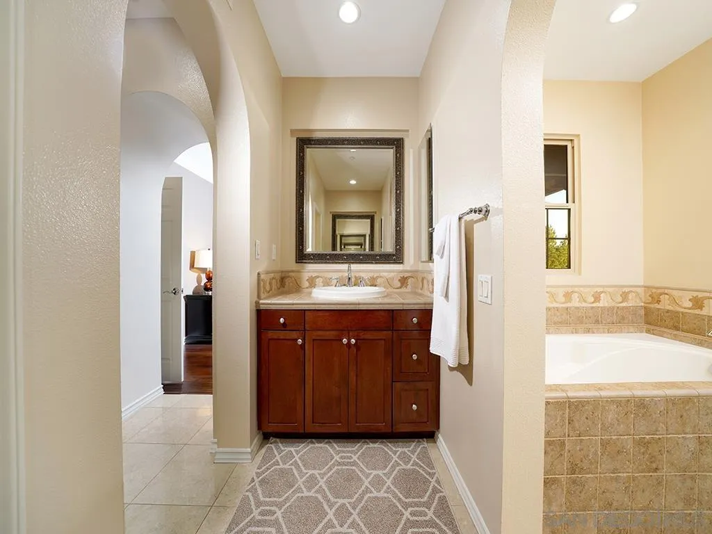 33 Tuscany Ladera Ranch, CA 92694 - Photo 17 of 50 a bathroom with a double vanity sink and a mirror