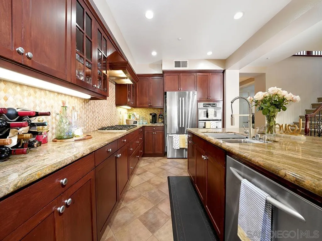 33 Tuscany Ladera Ranch, CA 92694 - Photo 6 of 50 a kitchen with stainless steel appliances granite countertop a sink counter space cabinets and a large window