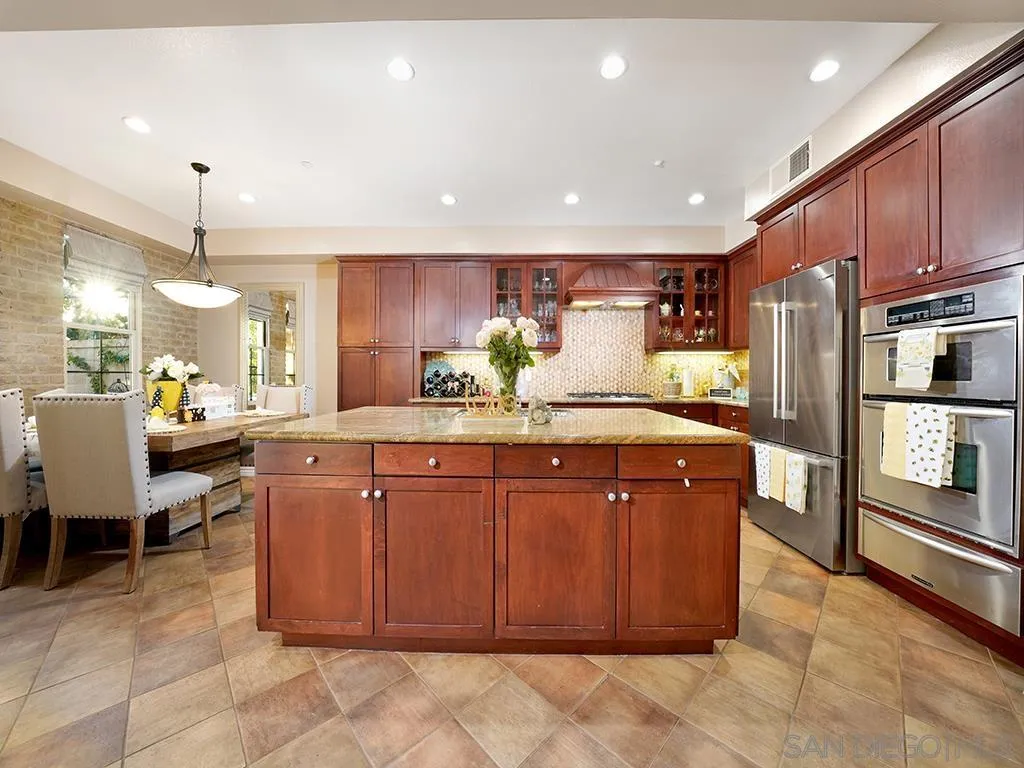 33 Tuscany Ladera Ranch, CA 92694 - Photo 8 of 50 a kitchen with stainless steel appliances a sink counter space and wooden cabinets