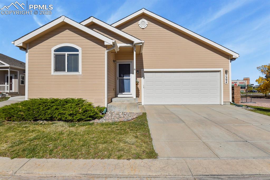 7394 Owings Point Peyton, CO 80831 - Photo 1 of 21 a front view of house with garage and yard