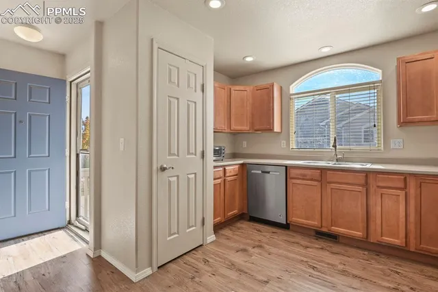 a kitchen with stainless steel appliances granite countertop a refrigerator and a sink