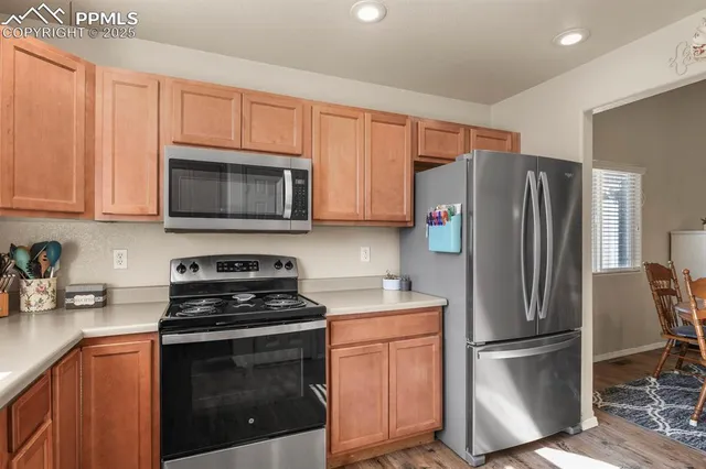 a kitchen with stainless steel appliances a refrigerator stove and microwave