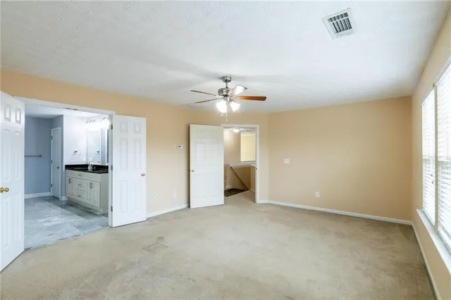 a view of a livingroom with a ceiling fan and window