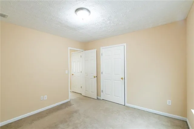 an empty room with a empty space and windows