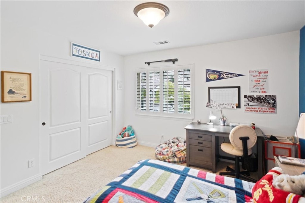 26511 Brooks Circle Stevenson Ranch, CA 91381 - Photo 35 of 55 a bedroom with a bed and a window