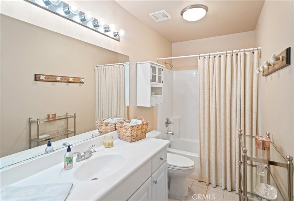 26511 Brooks Circle Stevenson Ranch, CA 91381 - Photo 42 of 55 a bathroom with a sink a toilet and shower curtain