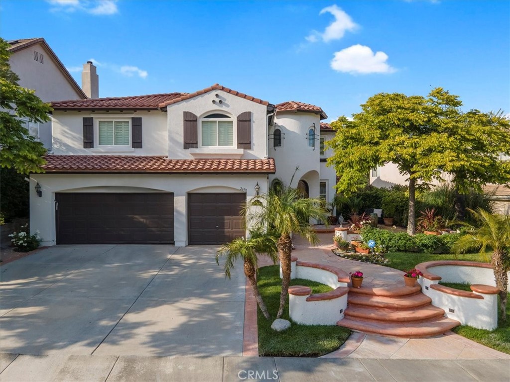 26511 Brooks Circle Stevenson Ranch, CA 91381 - Photo 52 of 55 a front view of a house with a garden and plants