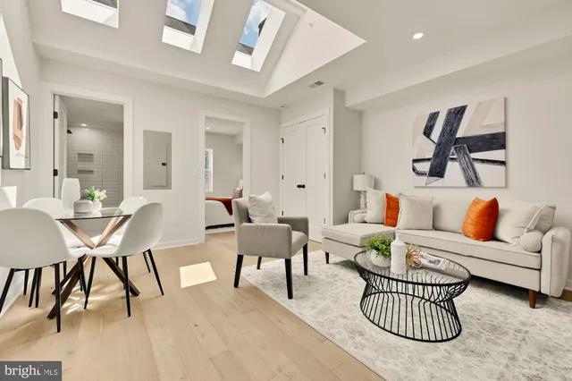 a living room with furniture a rug and a chandelier