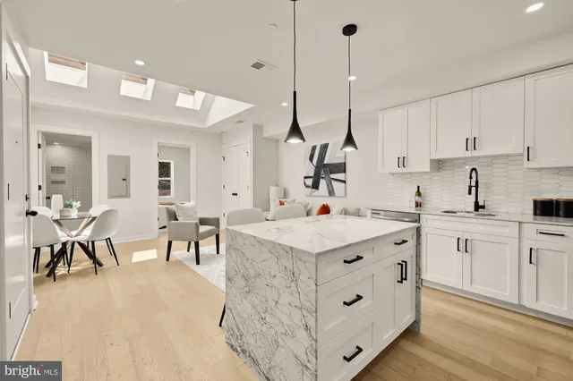 a kitchen with cabinets and chairs