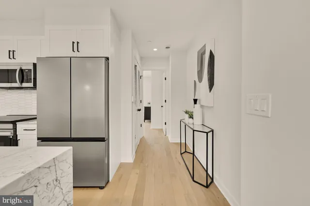 a view of a kitchen with refrigerator and microwave