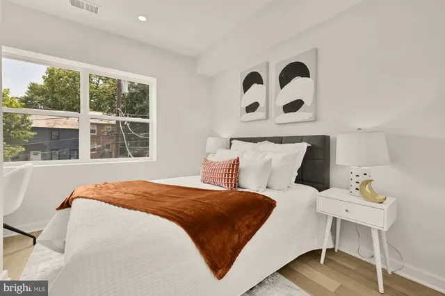 a large white bed in a white room