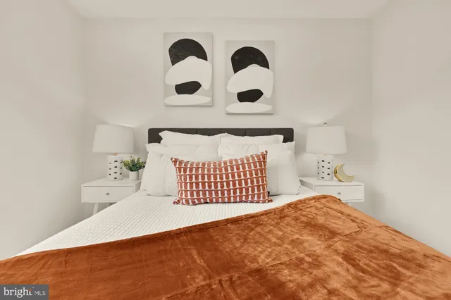 a bedroom with a bed and a black white wall