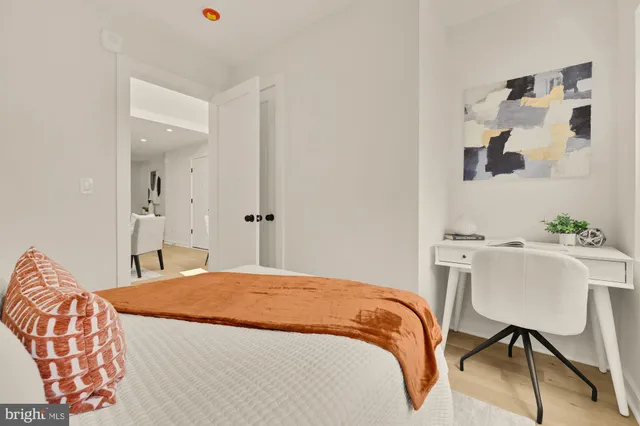 a bedroom with a bed and a table in it