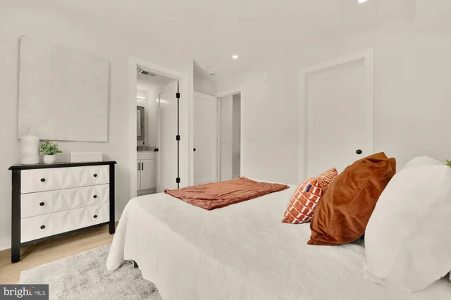 a bedroom with a bed and a dresser