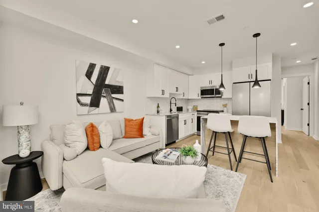 a living room with furniture and kitchen view