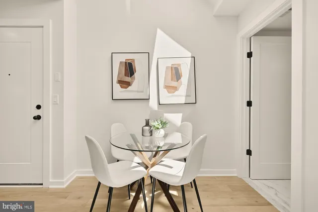 a dining room with furniture and wooden floor