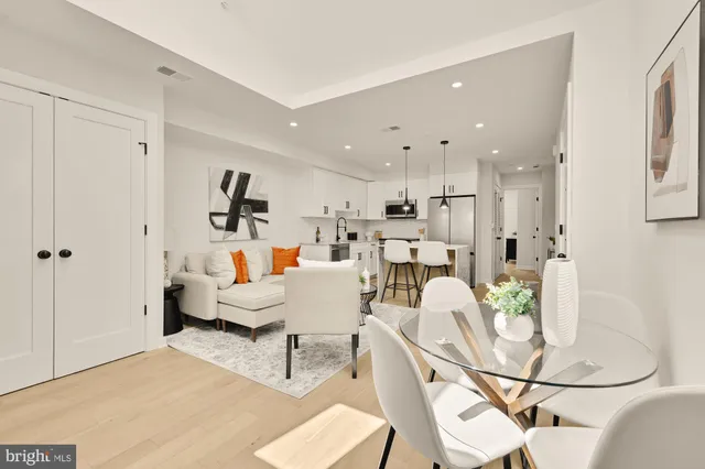 a living room with furniture and kitchen view