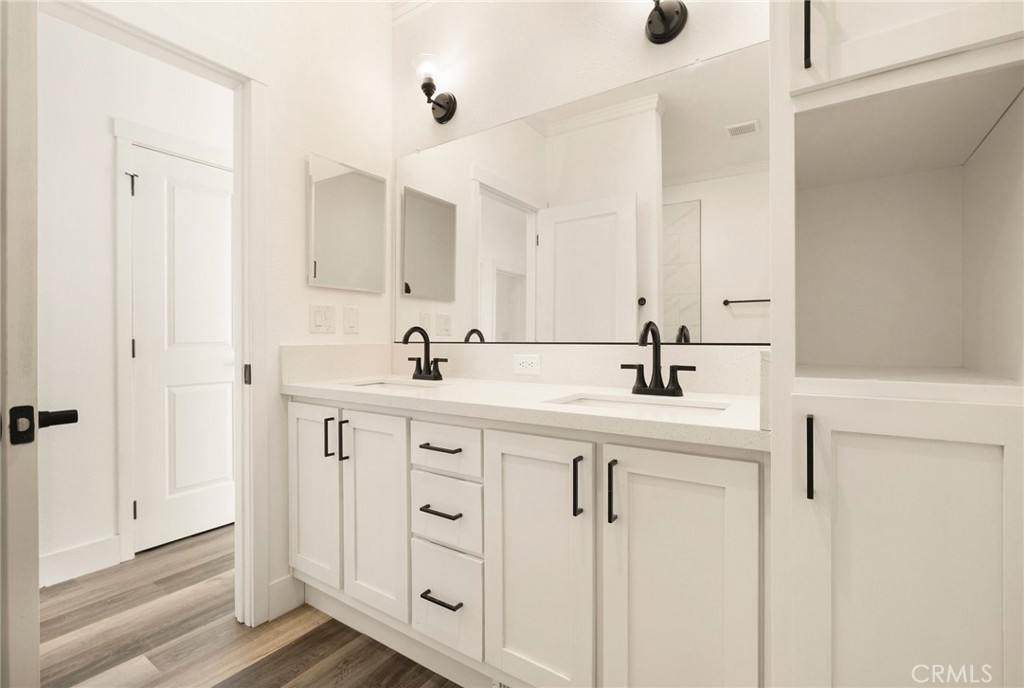 926 Bille Road Paradise, CA 95969 - Photo 15 of 28 a bathroom with a double vanity sink a mirror and shower