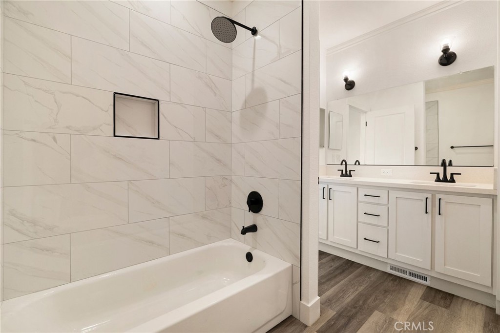 926 Bille Road Paradise, CA 95969 - Photo 16 of 28 a bathroom with a double vanity sink a mirror and a bathtub
