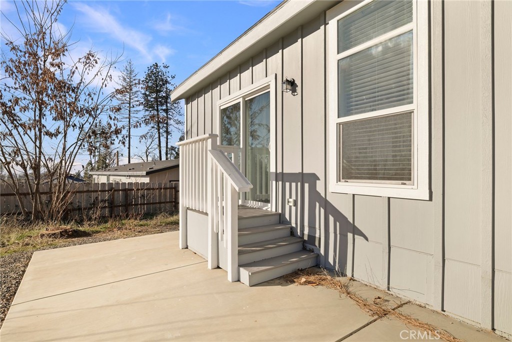 926 Bille Road Paradise, CA 95969 - Photo 24 of 28 a view of a house with wooden fence and a floor to ceiling window