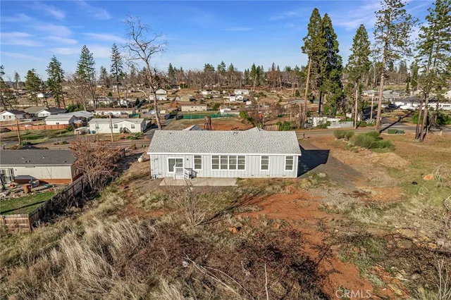 aerial view of a house with a yard