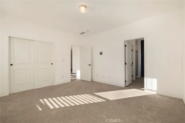 a view of empty room with stairs and a window