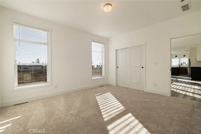a bathroom with a double vanity sink mirror and toilet