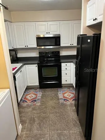 a kitchen with a sink stove and cabinets