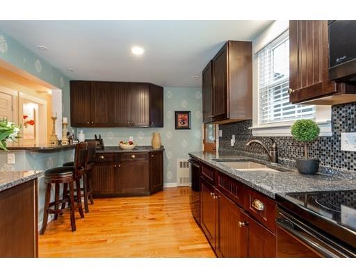 42 Gayland Road Needham, MA 02492 - Photo 9 of 22 a kitchen with stainless steel appliances granite countertop a sink stove and cabinets