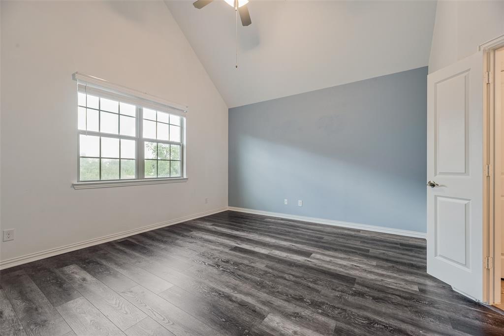 4670 I Rhett Lane, Unit I Carrollton, TX 75010 - Photo 15 of 31 Vaulted ceiling featuring a ceiling fan, wood-finish flooring, and a window with blinds