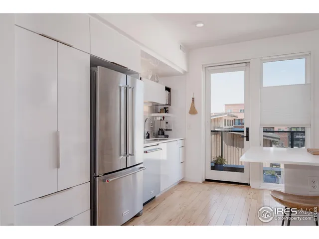 a kitchen with stainless steel appliances a stove and white cabinets