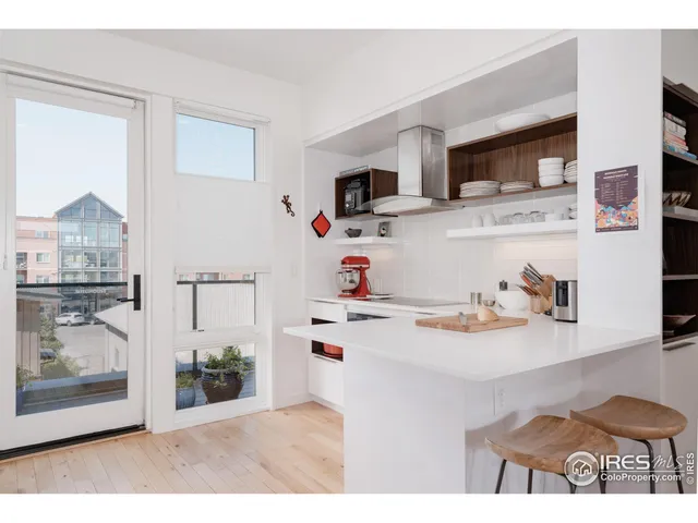 a kitchen with stainless steel appliances a refrigerator and a stove top oven