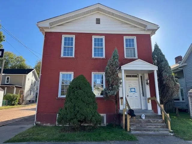 a front view of a house with garden
