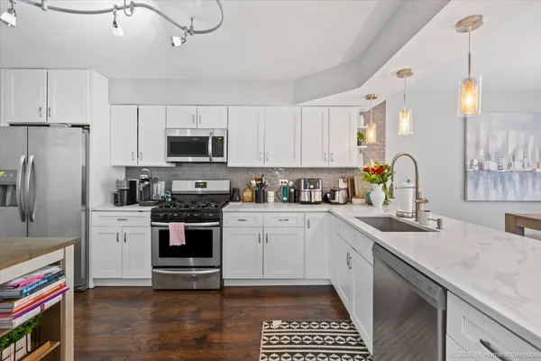 a kitchen with a sink stainless steel appliances and cabinets