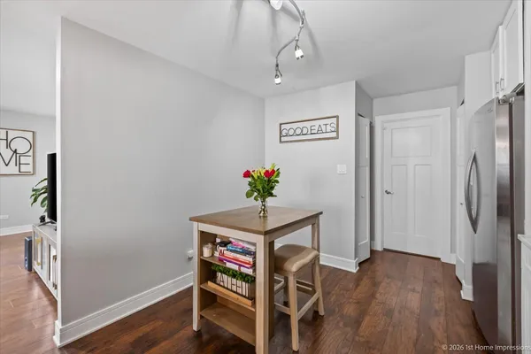 a view of a hallway with wooden floor and workspace