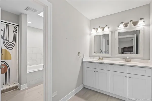 a bathroom with a double vanity sink and a mirror