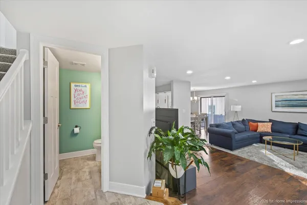 a living room with furniture flowerpot and a chandelier