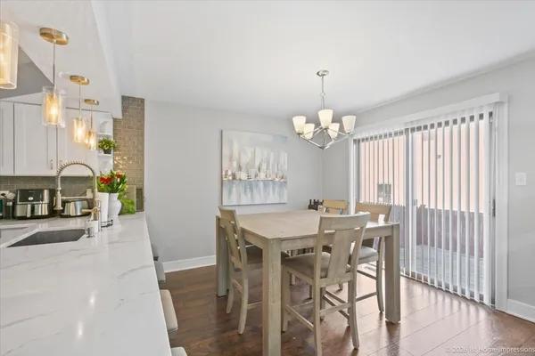 a view of a a dining room with furniture window and wooden floor