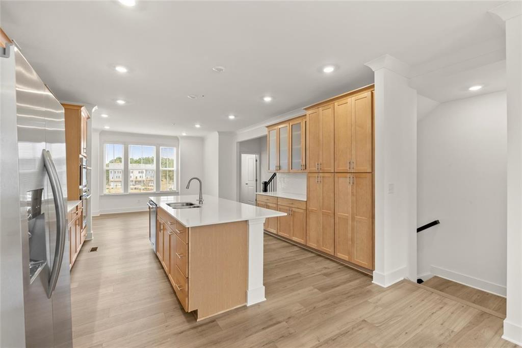 104 Agnew Way Woodstock, GA 30188 - Photo 14 of 47 a kitchen with stainless steel appliances granite countertop a refrigerator a sink and a stove with wooden floor