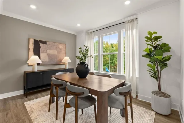 a view of a dining room with furniture window and wooden floor