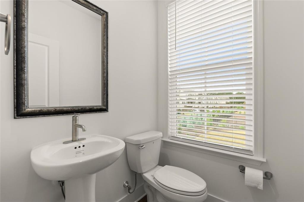 104 Agnew Way Woodstock, GA 30188 - Photo 17 of 47 a bathroom with a sink a toilet and a mirror