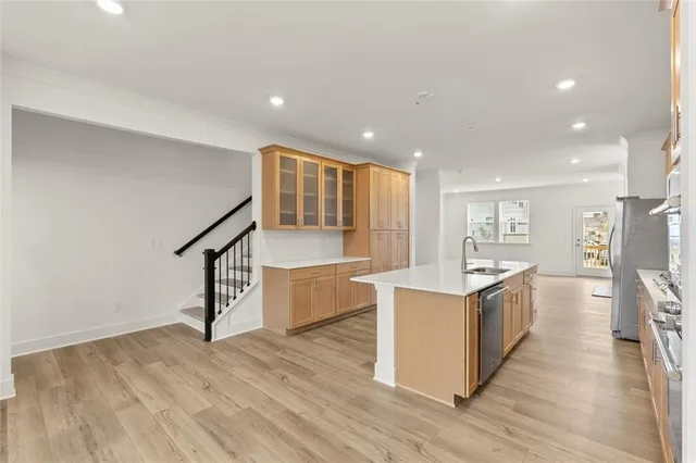 a open kitchen with stainless steel appliances granite countertop a stove and a sink