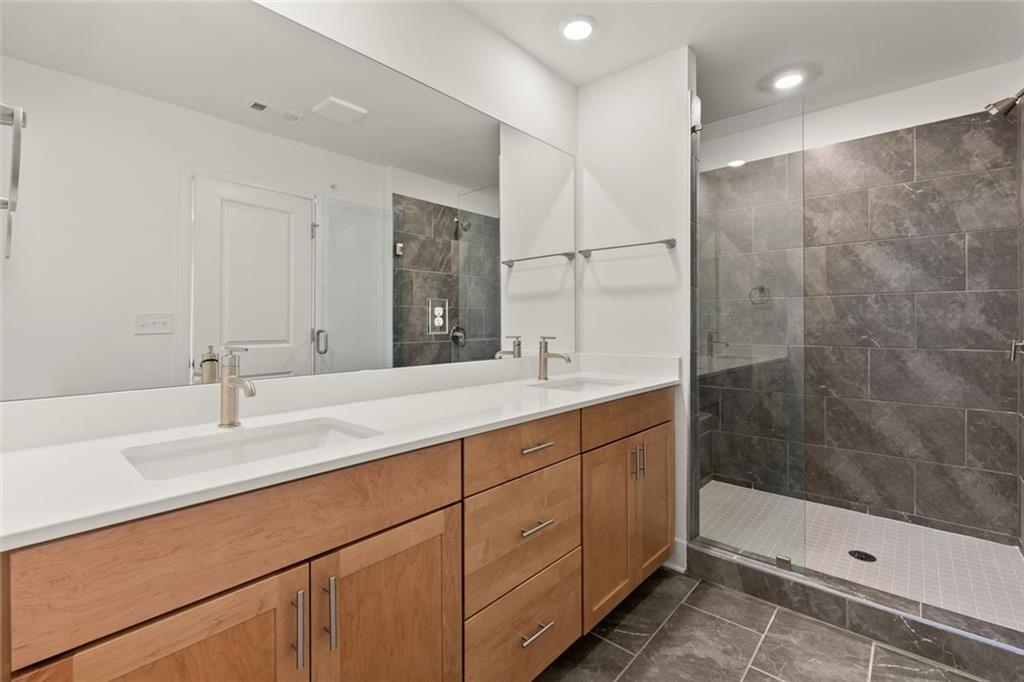104 Agnew Way Woodstock, GA 30188 - Photo 22 of 47 a bathroom with double vanity and a shower