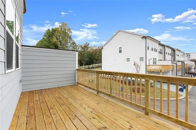 a view of a balcony with wooden floor and fence