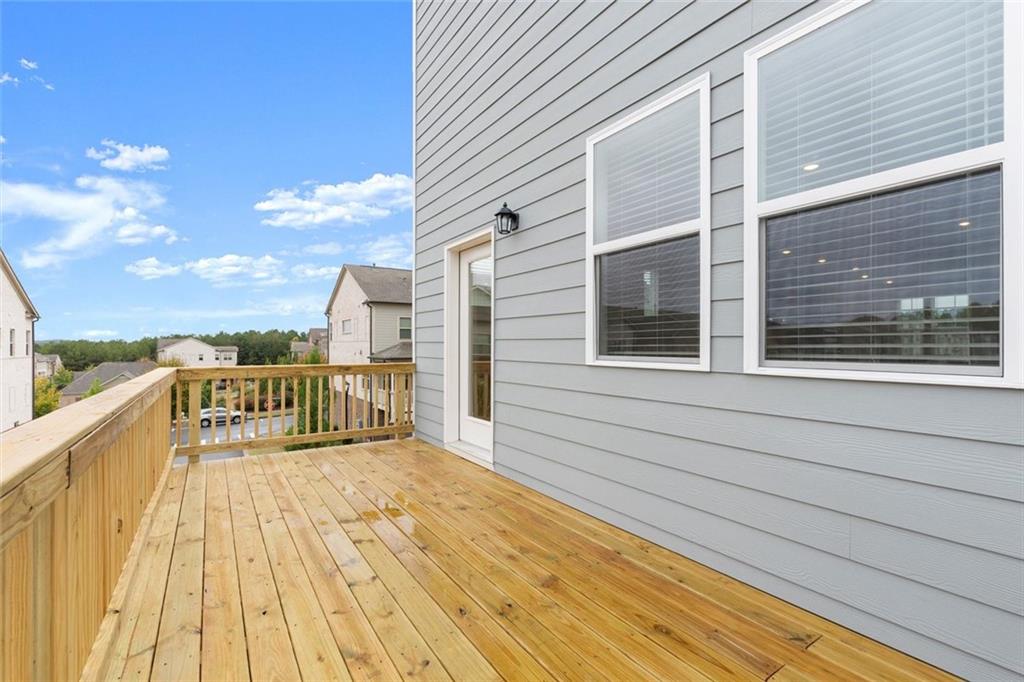 104 Agnew Way Woodstock, GA 30188 - Photo 30 of 47 a view of a balcony with wooden floor and fence